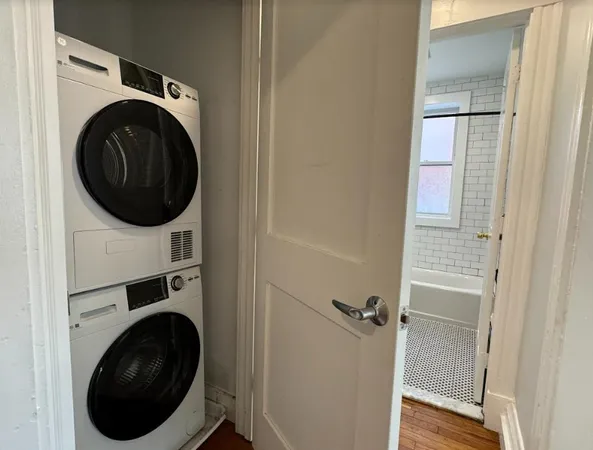 a view of a hallway with washer and dryer