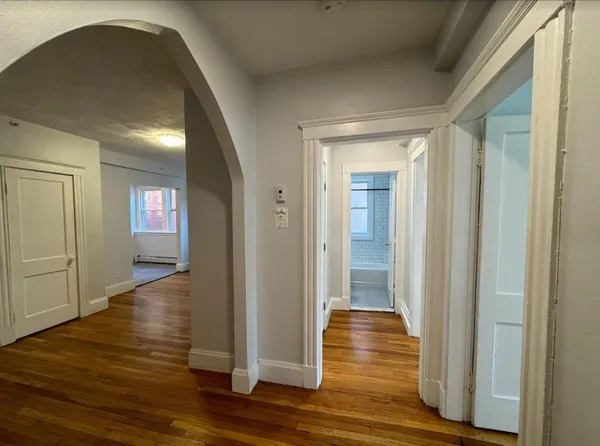a view of empty room with wooden floor