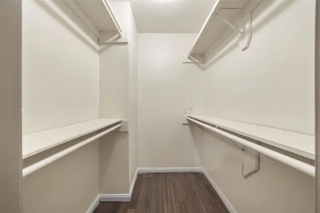 a view of closet with wooden floor