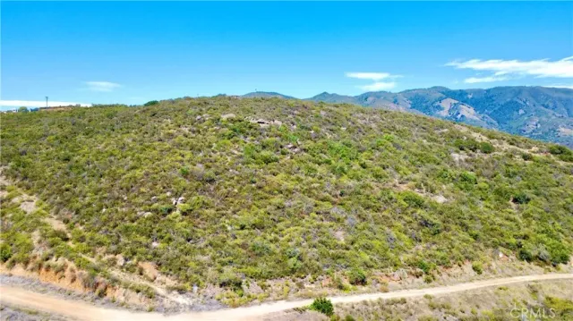 a view of a large mountain with mountains in the background