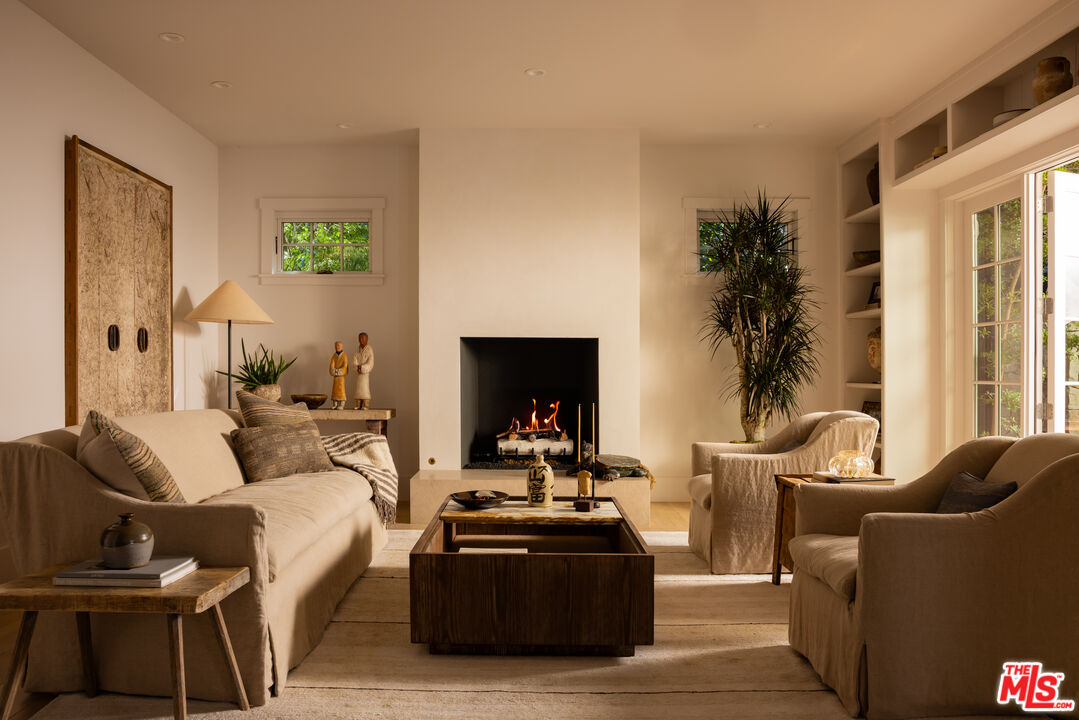 664 Elkins Road Los Angeles, CA 90049 - Photo 12 of 40 a living room with furniture and a fireplace