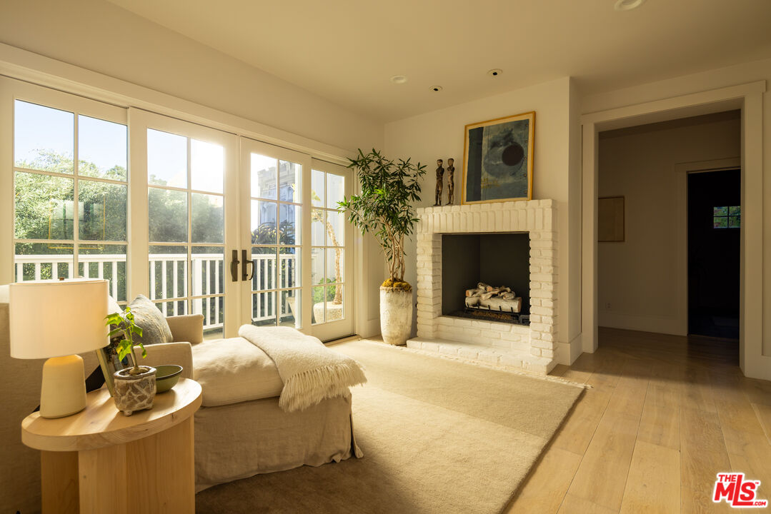 664 Elkins Road Los Angeles, CA 90049 - Photo 19 of 40 a bedroom with furniture and a fireplace