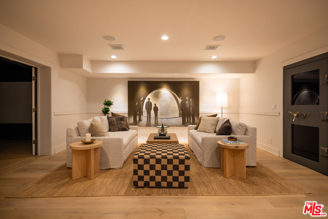 664 Elkins Road Los Angeles, CA 90049 - Photo 27 of 40 a living room with furniture a fireplace and a flat screen tv