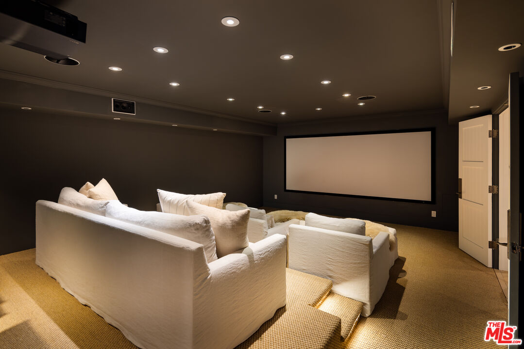664 Elkins Road Los Angeles, CA 90049 - Photo 29 of 40 a living room with furniture and a projector screen