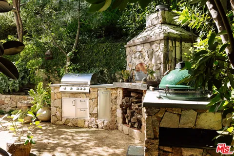 a side view of a chairs and table in the patio