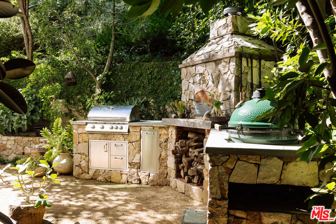 664 Elkins Road Los Angeles, CA 90049 - Photo 33 of 40 a side view of a chairs and table in the patio