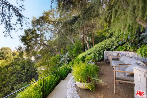 a backyard of a house with a yard and outdoor seating