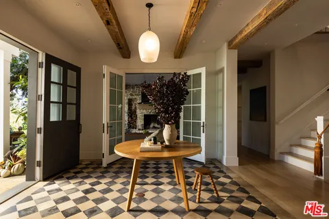 a living room with a table and a potted plant
