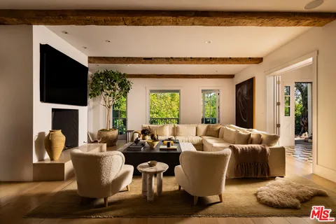 a living room with furniture wooden floor and a flat screen tv