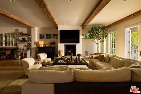 a living room with furniture fireplace and flat screen tv