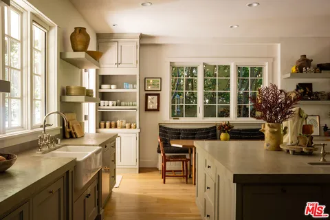 a kitchen with a sink cabinets and window