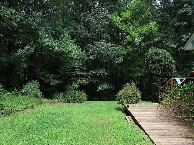 8728 Danbury Circle Raleigh, NC 27613 - Photo 22 of 25 Side yard showing lower deck, gardens and your own private "park like" setting.