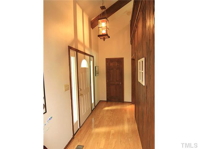 8728 Danbury Circle Raleigh, NC 27613 - Photo 3 of 25 Lovely entrance to this wonderful home. Catherdral ceiling, natural wood beams, and gorgeous hardwood floors.