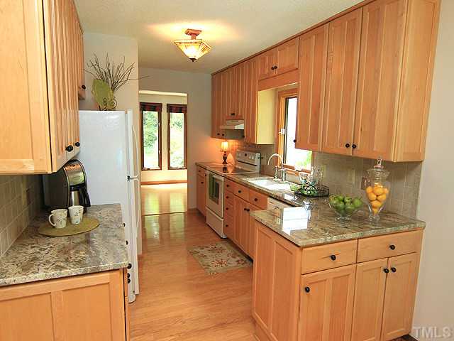 8728 Danbury Circle Raleigh, NC 27613 - Photo 9 of 25 Beautiful solid maple cabinets supplying ample storage in this chefs kitchen.