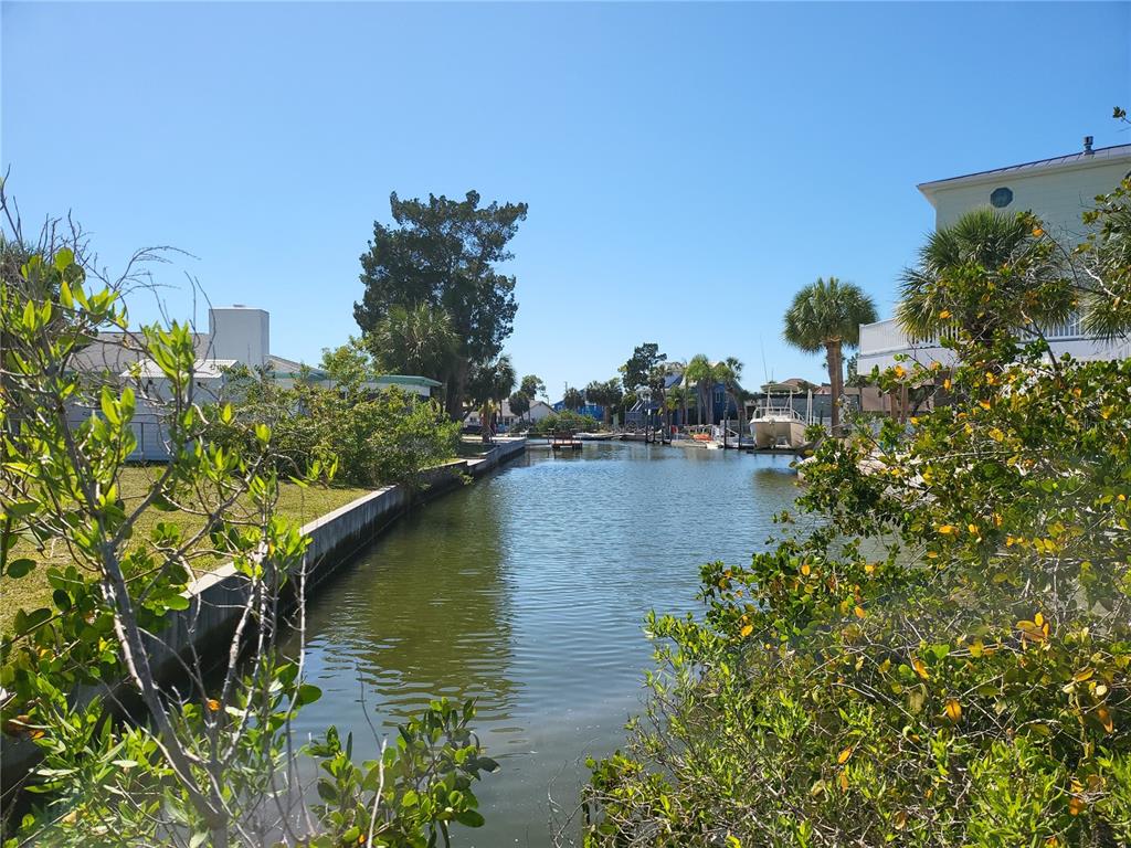 3463 Paragon Terrace Hernando Beach, FL 34607 - Photo 8 of 12 a view of a lake with a house in the background