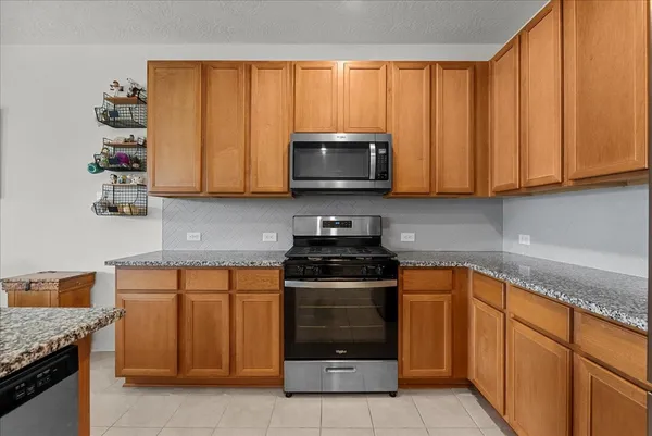 a kitchen with stainless steel appliances granite countertop a refrigerator sink and cabinets