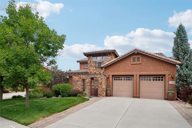 2204 Rocking Horse Court Colorado Springs, CO 80921 - Photo 3 of 50 Mediterranean / spanish home with a garage and a front lawn