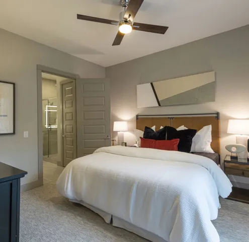 a bedroom with a bed and a lamp