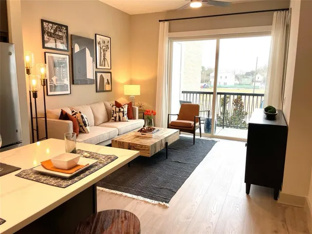 a living room with furniture and a large window