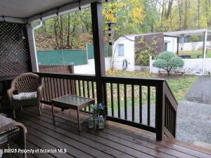a view of a two chairs and table in the balcony