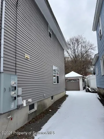a view of a white house with a small yard