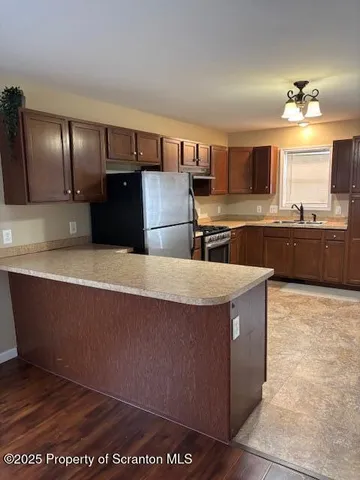 a kitchen with kitchen island cabinets and refrigerator