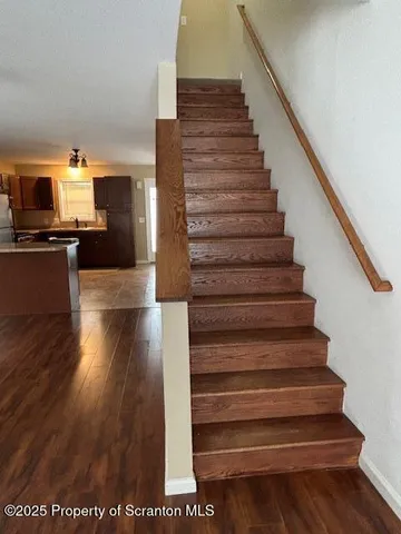 a view of entryway and hall with wooden floor