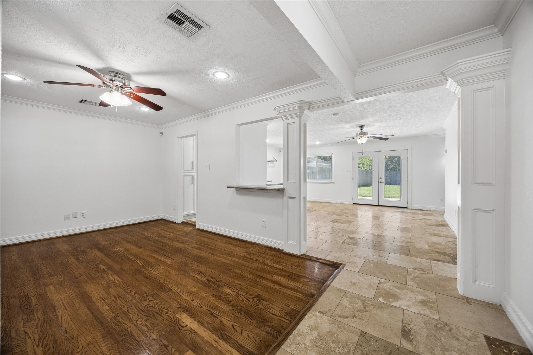5019 Kinglet Street Houston, TX 77035 - Photo 6 of 24 Open concept living boasting beautiful flooring & exquisite mill work! Note green views of large backyard through recently replaced French doors.