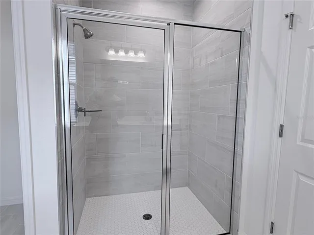 a bathroom with a glass shower door