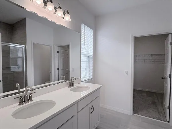 a bathroom with a sink double vanity and a mirror