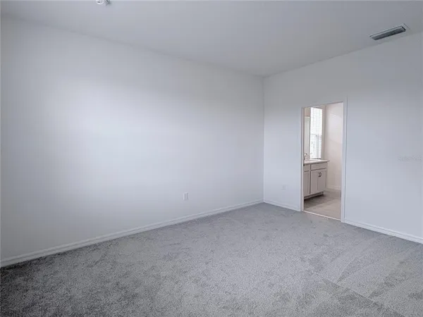 an empty room with a window and closet