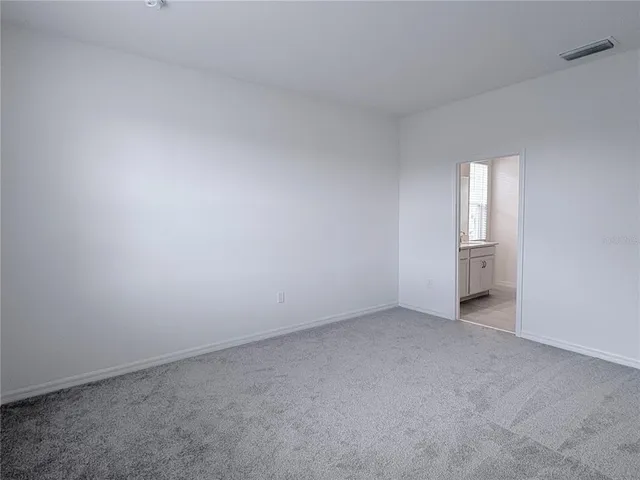an empty room with a window and closet