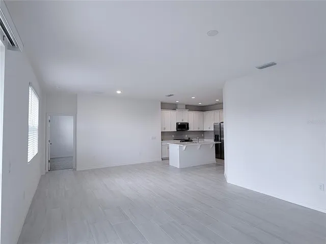 a view of a kitchen with microwave and stove top oven