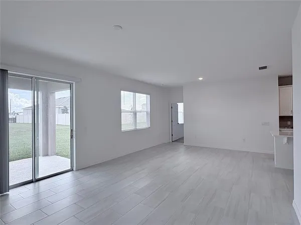 a view of an empty room with glass door