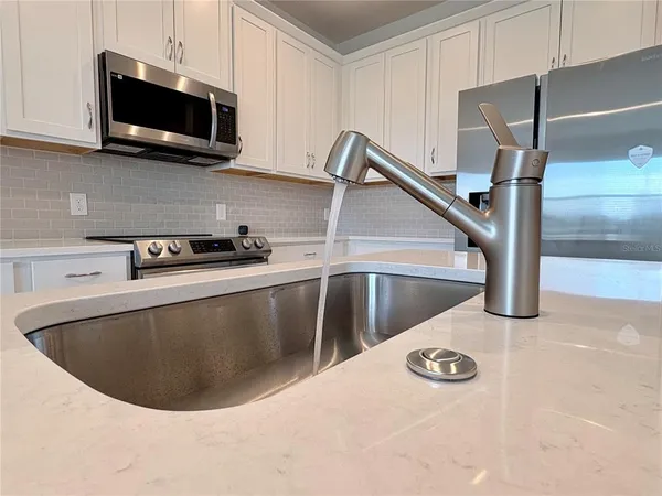 a kitchen with a stove and a microwave