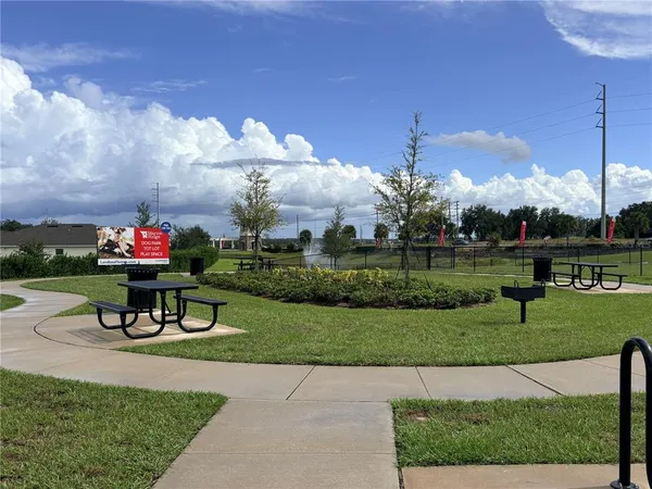 a view of a house with a yard and sitting area