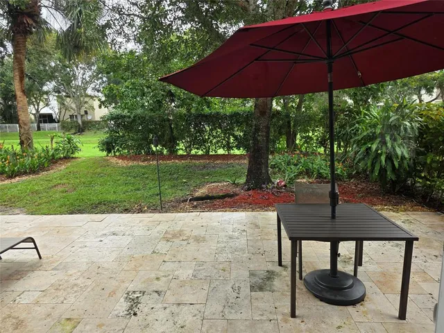 a table and chairs under an umbrella