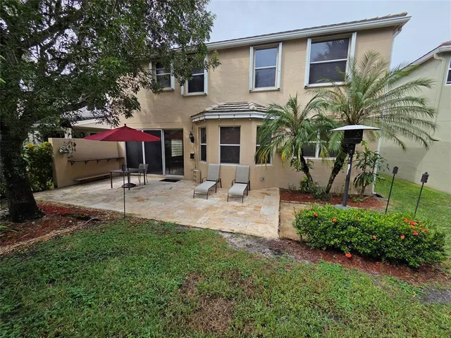 a front view of house with yard and outdoor seating