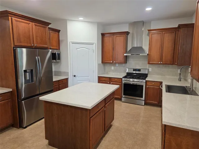a kitchen with stainless steel appliances a refrigerator stove and sink