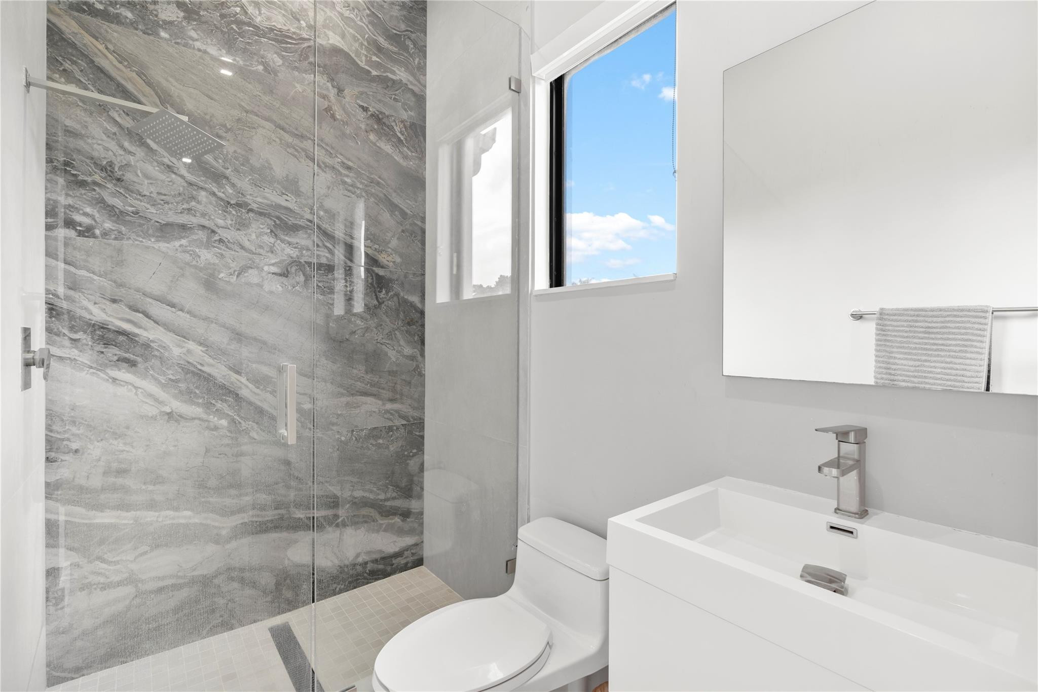 13605 Bella Ranch Lane Southwest Ranches, FL 33330 - Photo 46 of 81 a white toilet sitting next to a bathroom sink