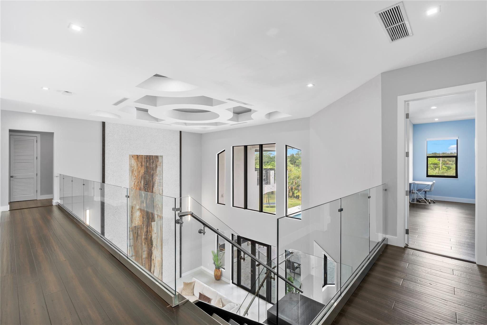 13605 Bella Ranch Lane Southwest Ranches, FL 33330 - Photo 51 of 81 a view of a hallway with wooden floor and stairs