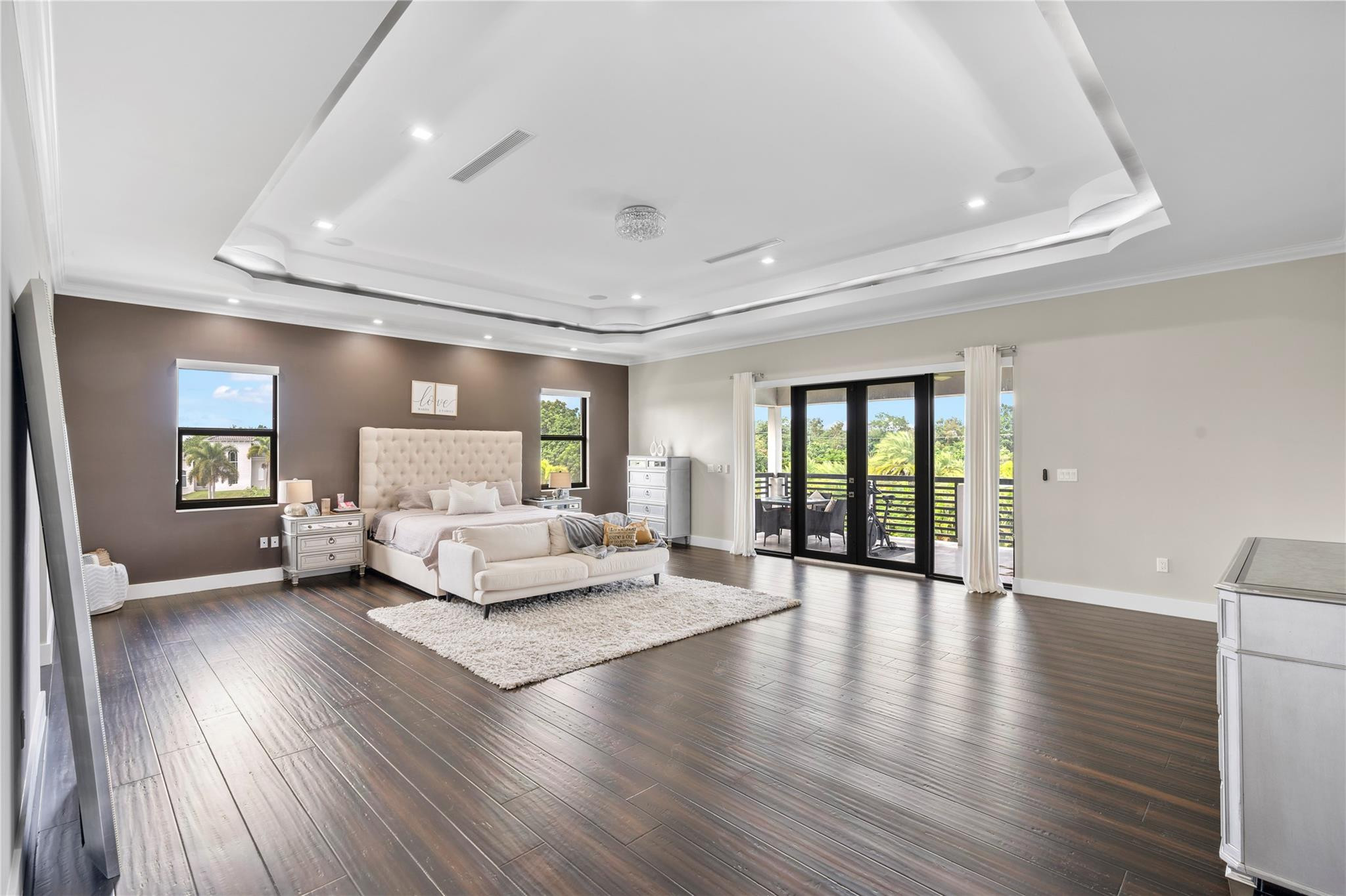 13605 Bella Ranch Lane Southwest Ranches, FL 33330 - Photo 56 of 81 a spacious bedroom with a balcony a bed and a wooden floor