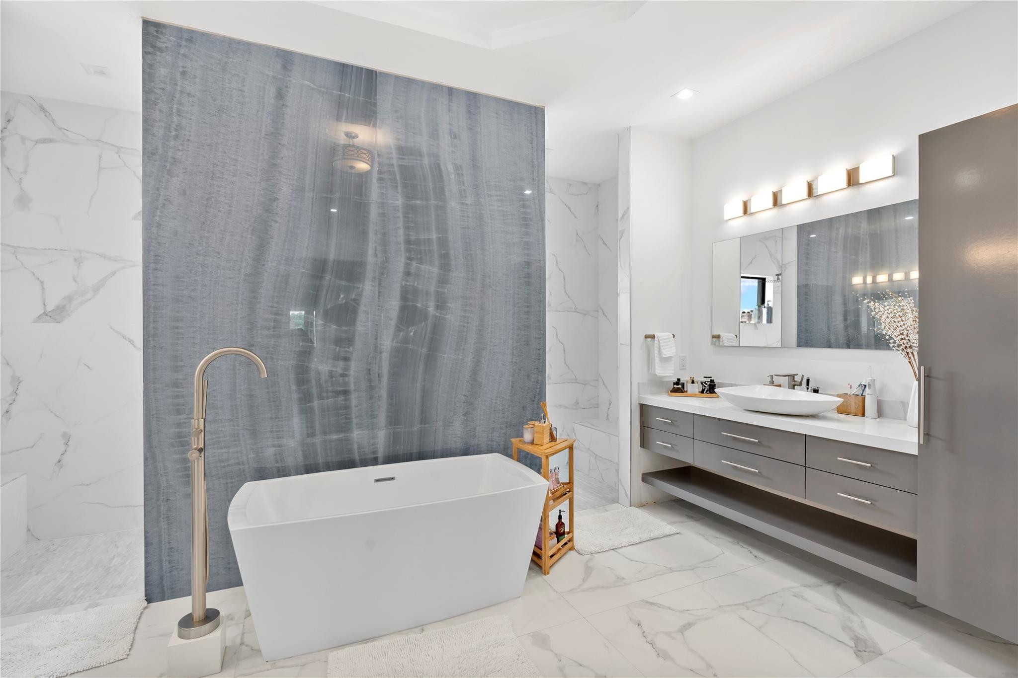 13605 Bella Ranch Lane Southwest Ranches, FL 33330 - Photo 60 of 81 a bathroom with a tub a sink and a mirror