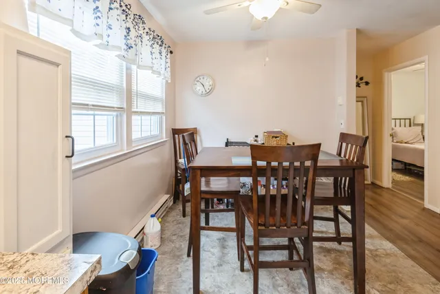 a view of a dining room with furniture and wooden floor