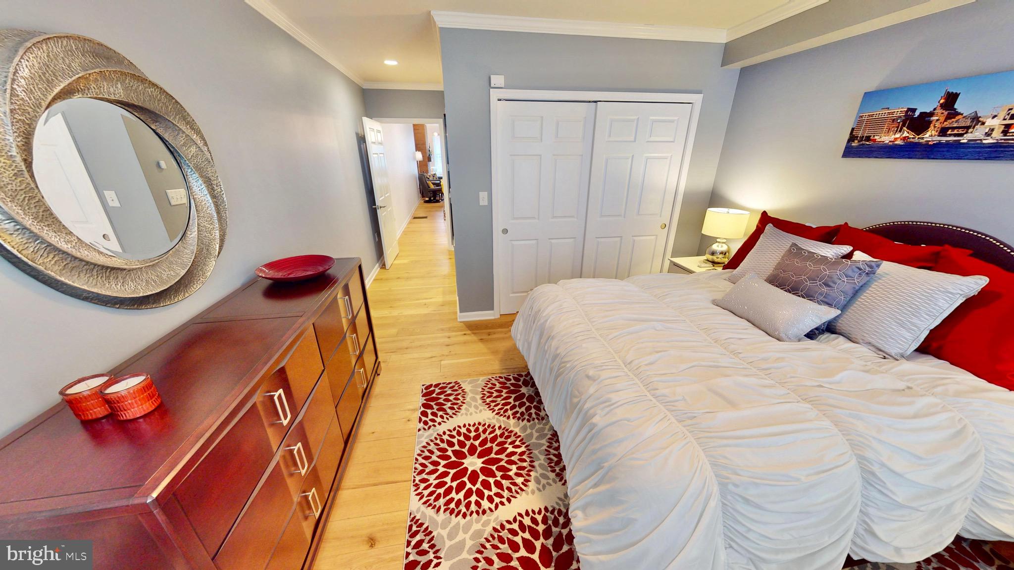 306 South Exeter Street Baltimore, MD 21202 - Photo 11 of 35 a bedroom with a bed and a chandelier