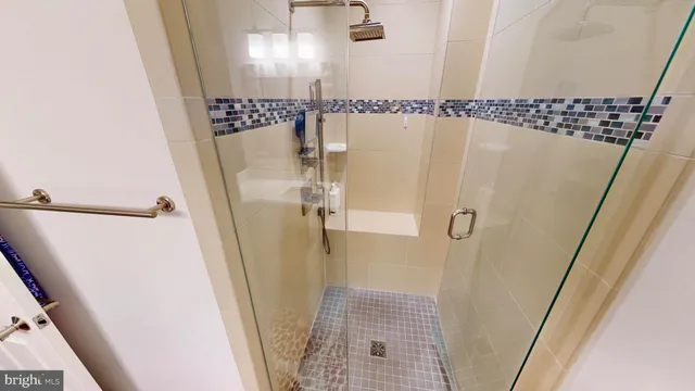 a bathroom with a shower and a sink