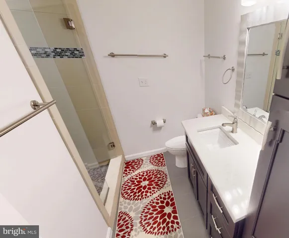 a bath room with a sink and a mirror