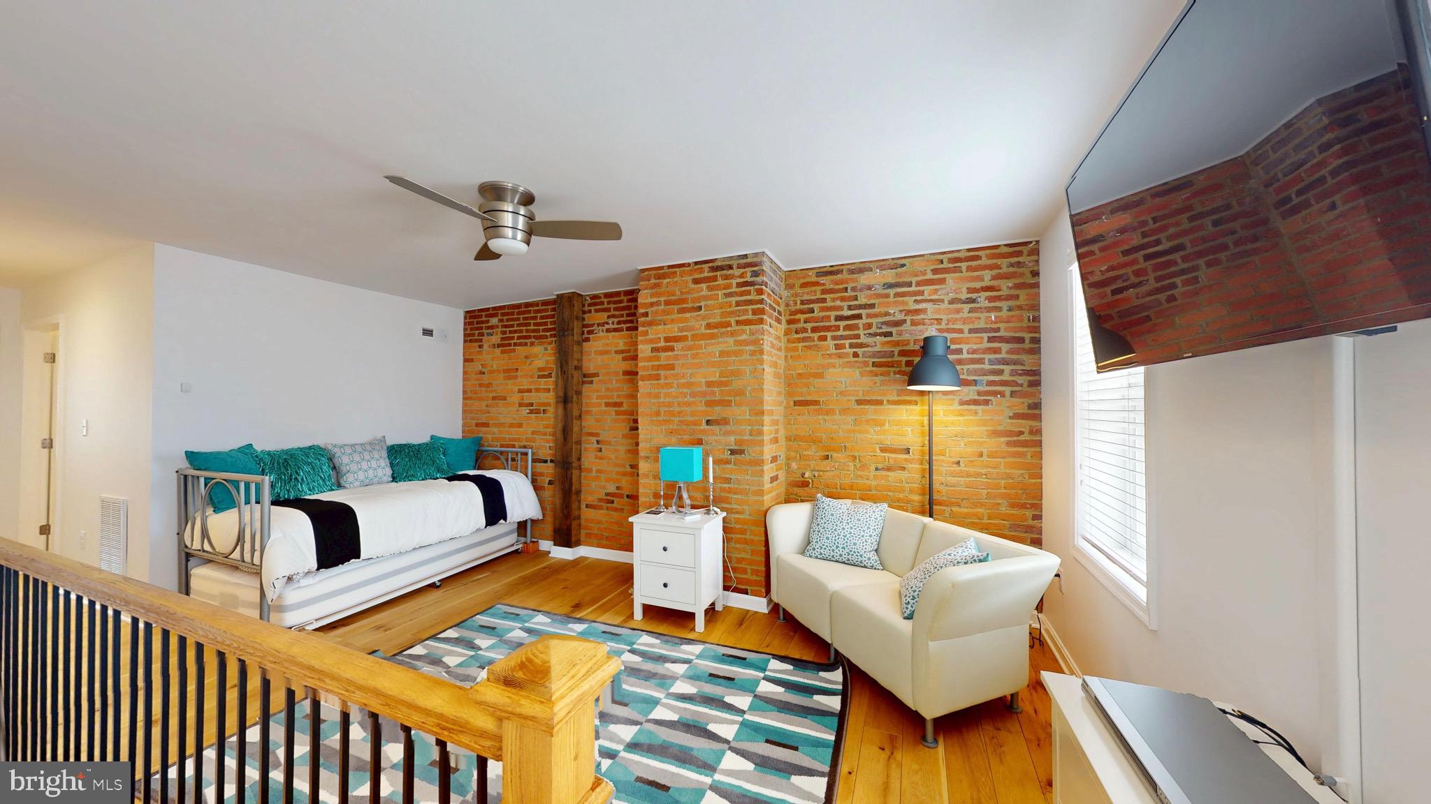 306 South Exeter Street Baltimore, MD 21202 - Photo 16 of 35 a living room with furniture and a floor to ceiling window