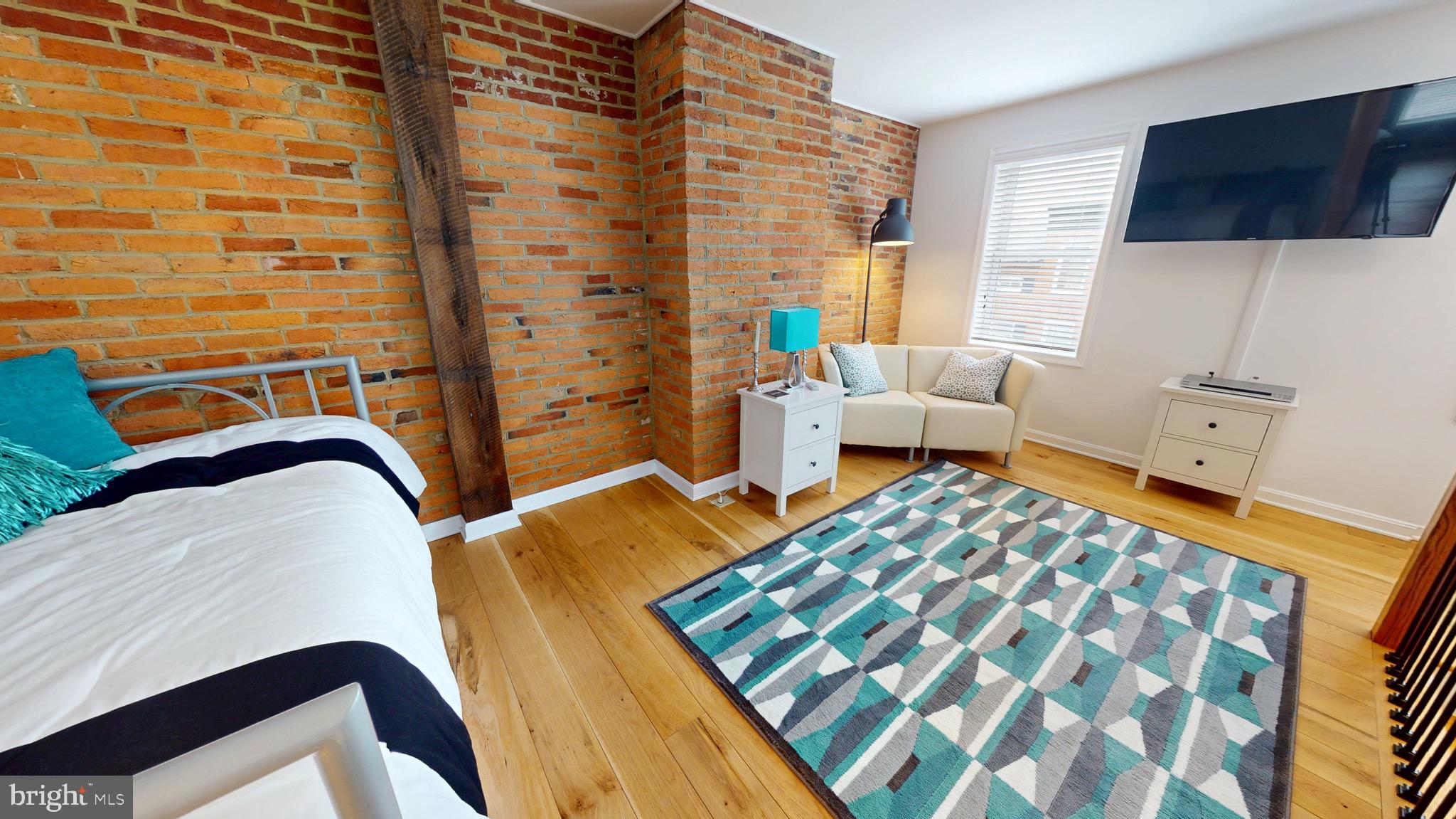 306 South Exeter Street Baltimore, MD 21202 - Photo 17 of 35 a bedroom with a bed and a couch