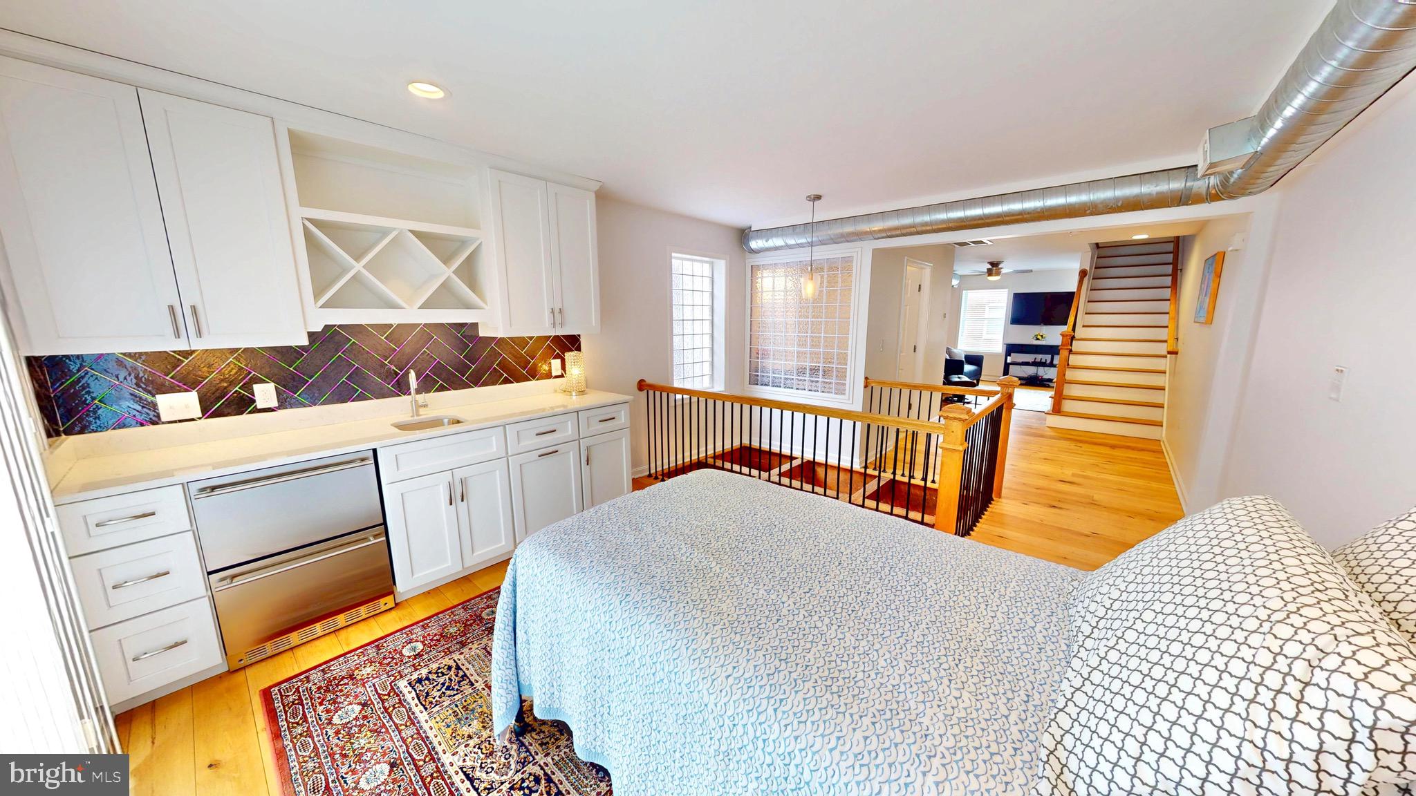 306 South Exeter Street Baltimore, MD 21202 - Photo 29 of 35 a bedroom with a bed and wooden floor